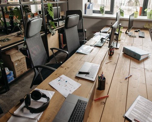 organized work desk with water and natural light in an office